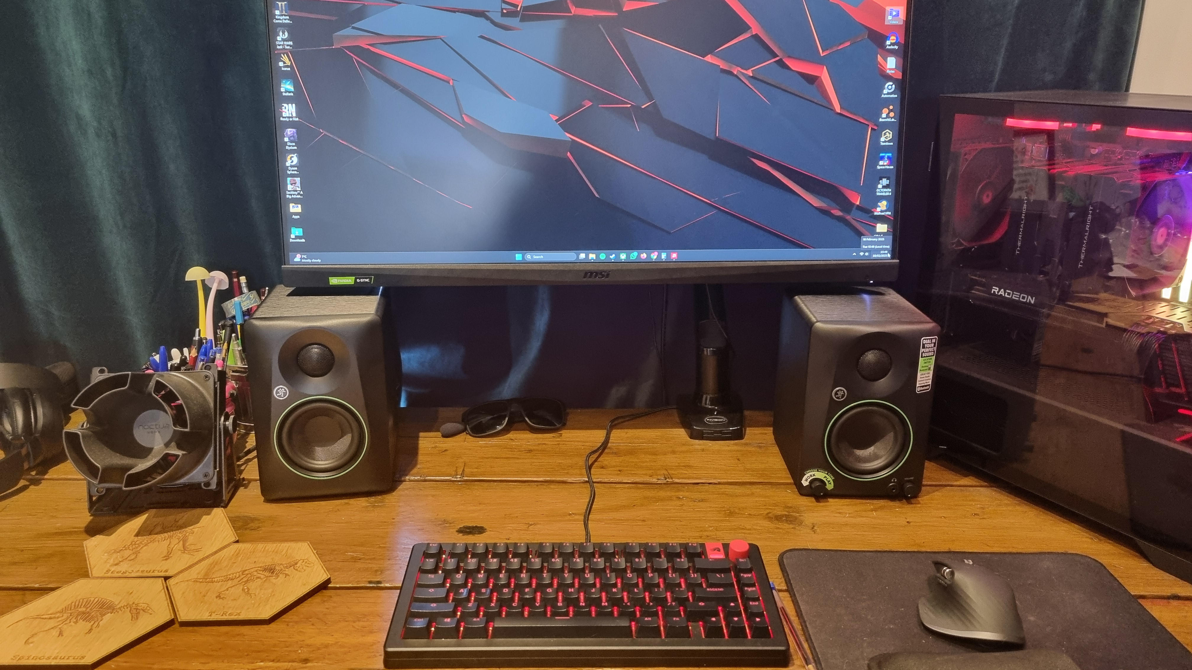 The Mackie CR3.5 BT reference speakers on a desk setup, with monitor positioned above and a gaming keyboard in the front of shot