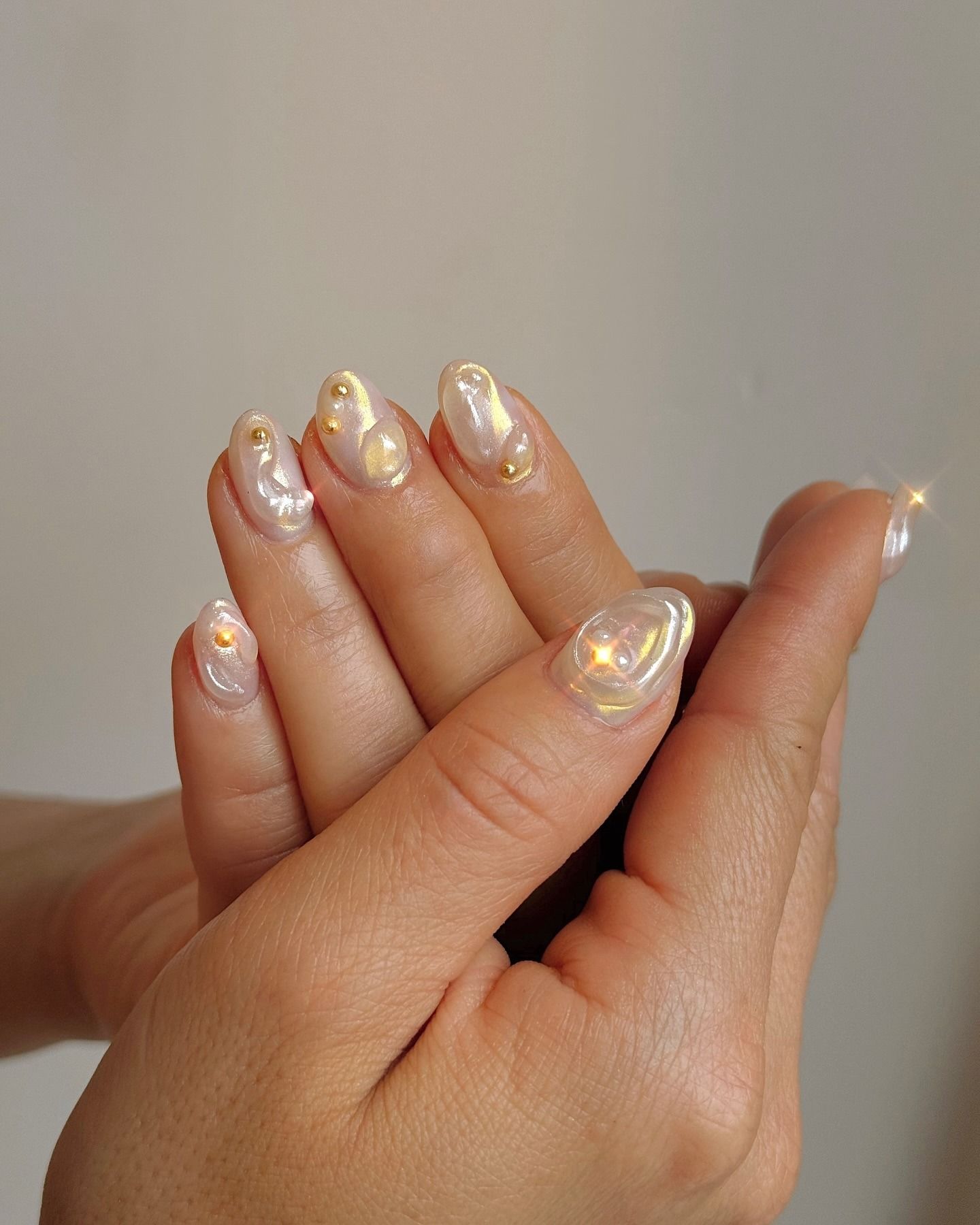 A person with glazed 3D nails.