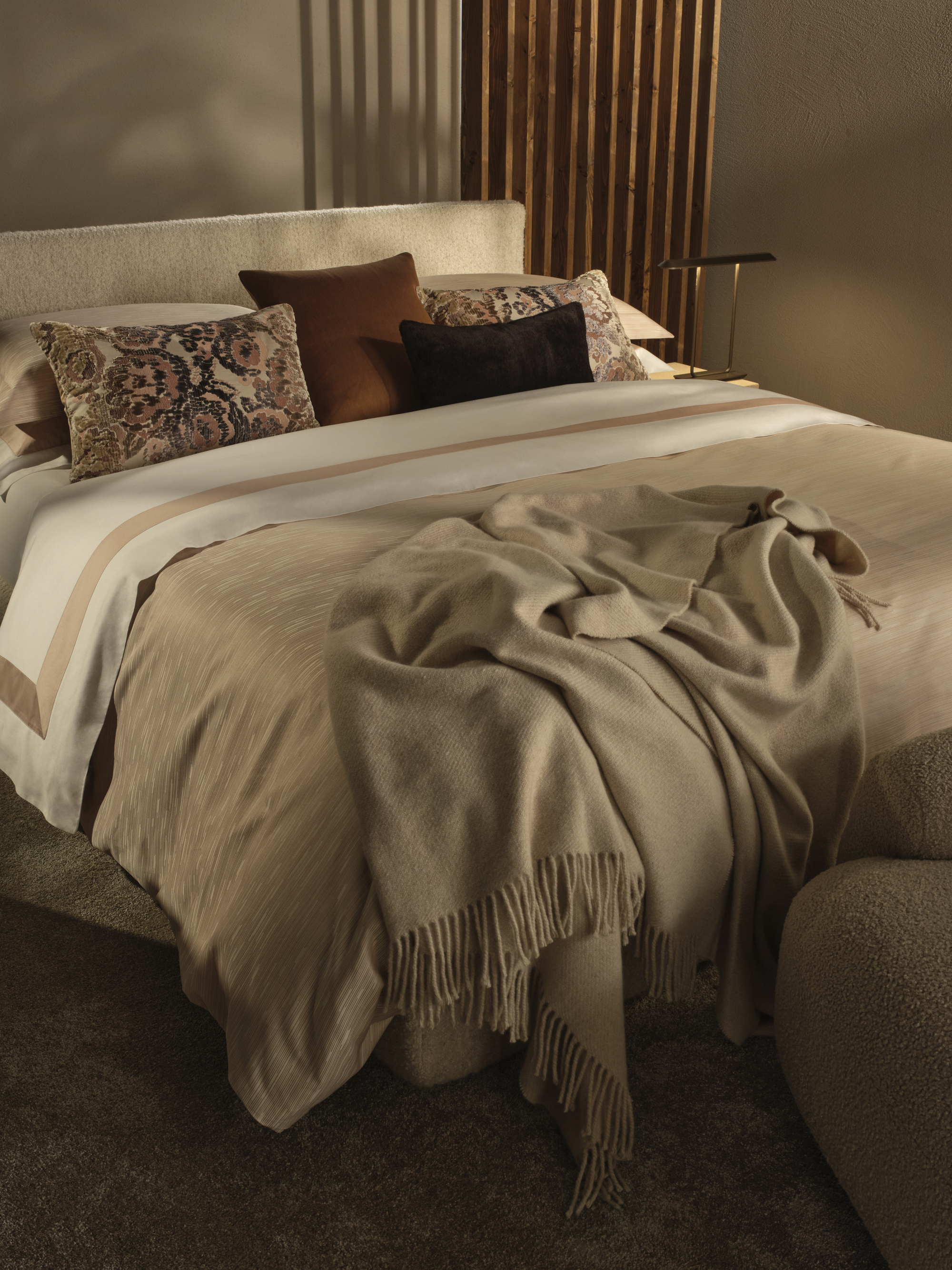 A king sized bed with neutral bedding
