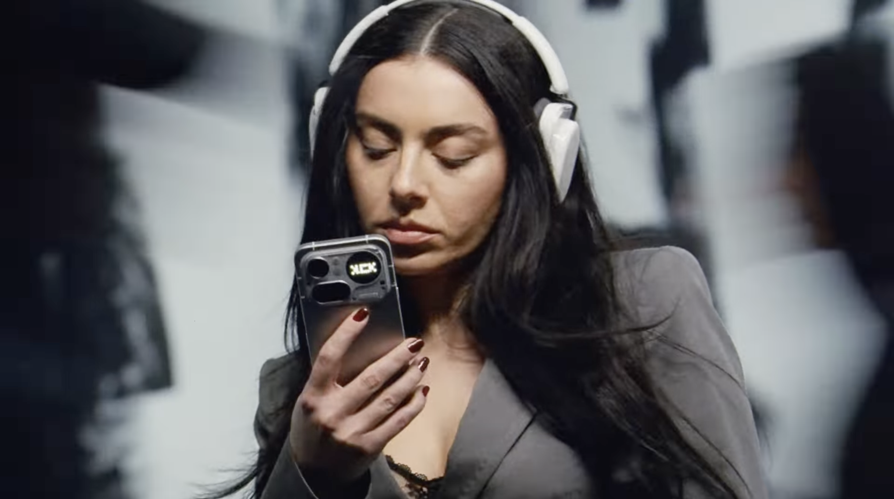 Charli xcx checks the Nothing Phone 4a during the NOTHING (CHARLI XCX) commercial