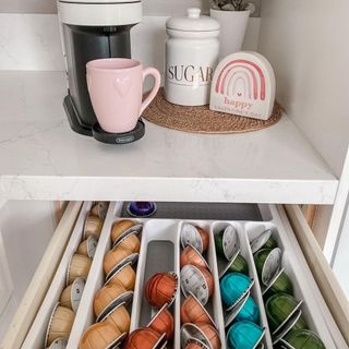 Coffee pod storage solution in drawer by coffee station.