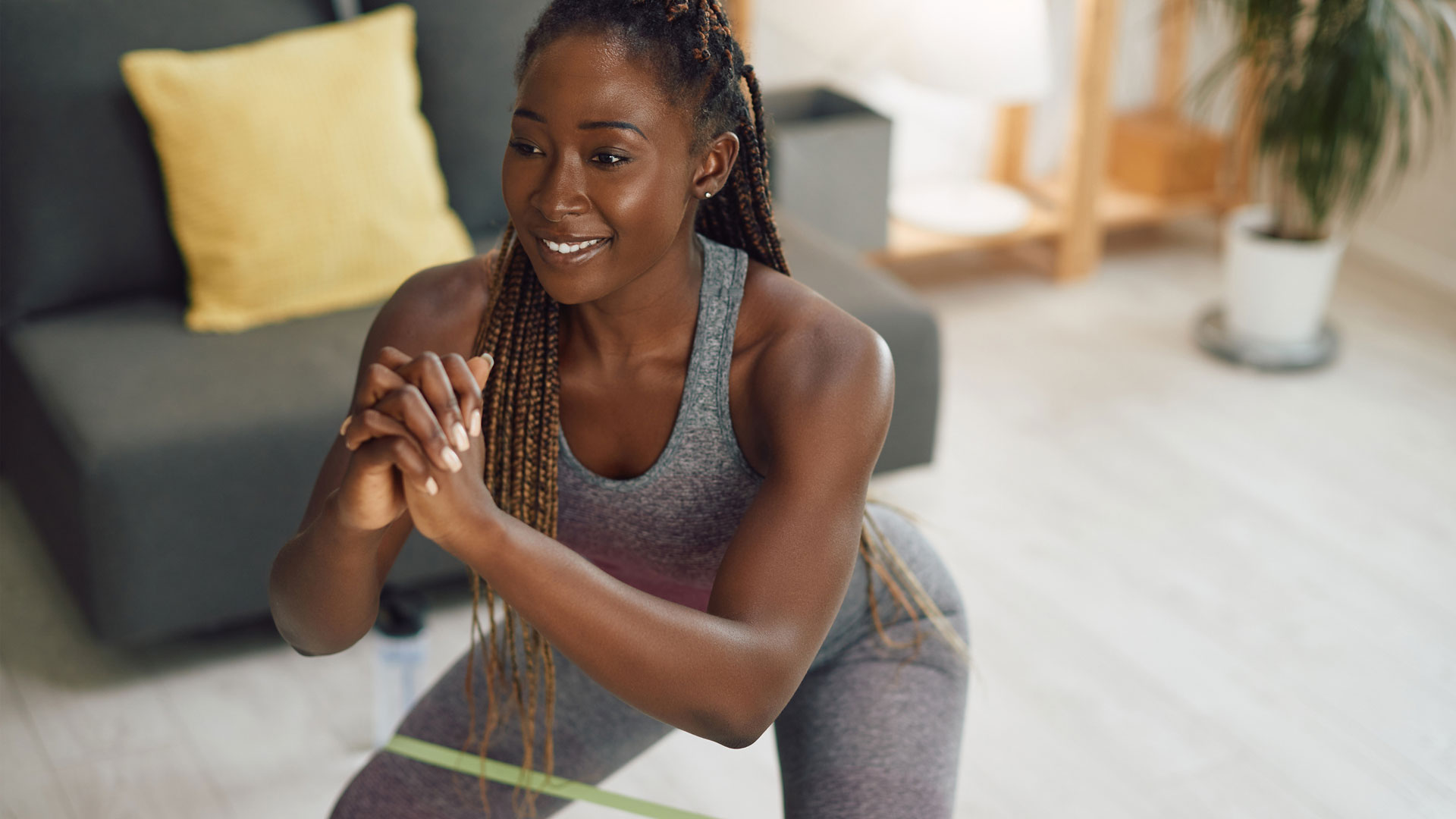 How to squat in a resistance band: a woman exercising in a resistance band