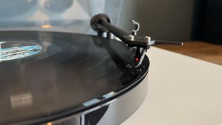 A close-up shot of the Pro-Ject E1 turntable in white