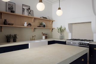 Engineered white cement-effect countertops in modern neutral kitchen with open shelving