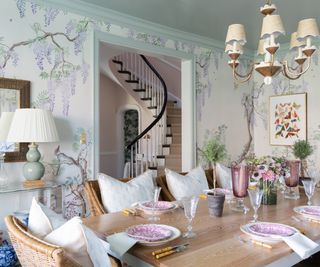 dining room with floral patterned wallcovering and view to stairs