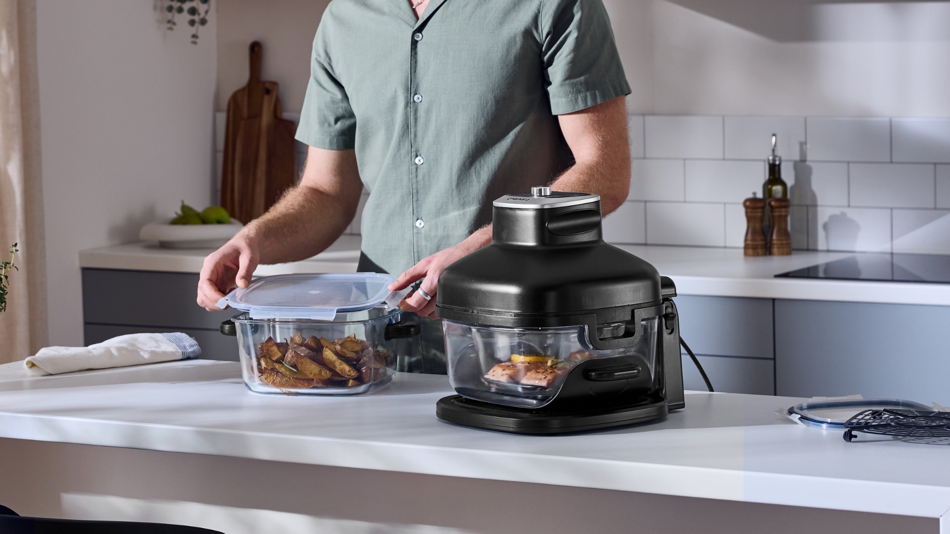 Lidl SilverCrest Glass Air Fryer on a counter, being used to cook two different dishes