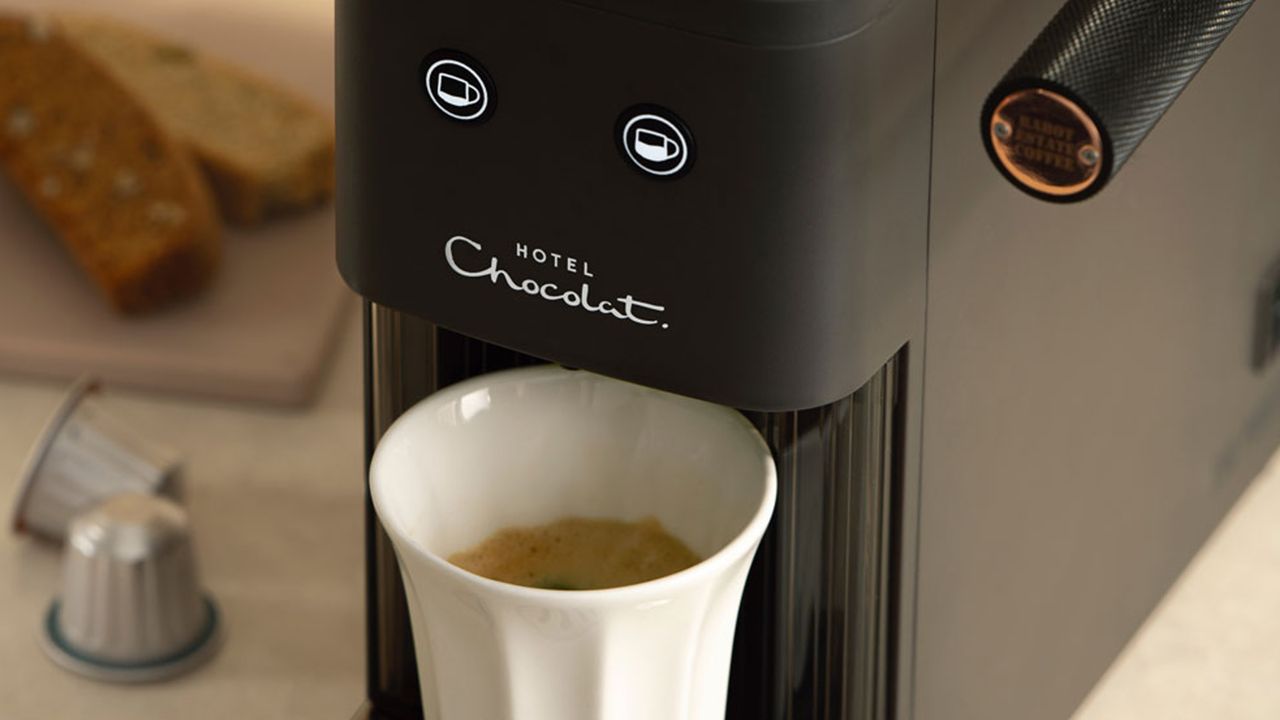 Hotel Chocolat Podster coffee machine pouring coffee into white cup