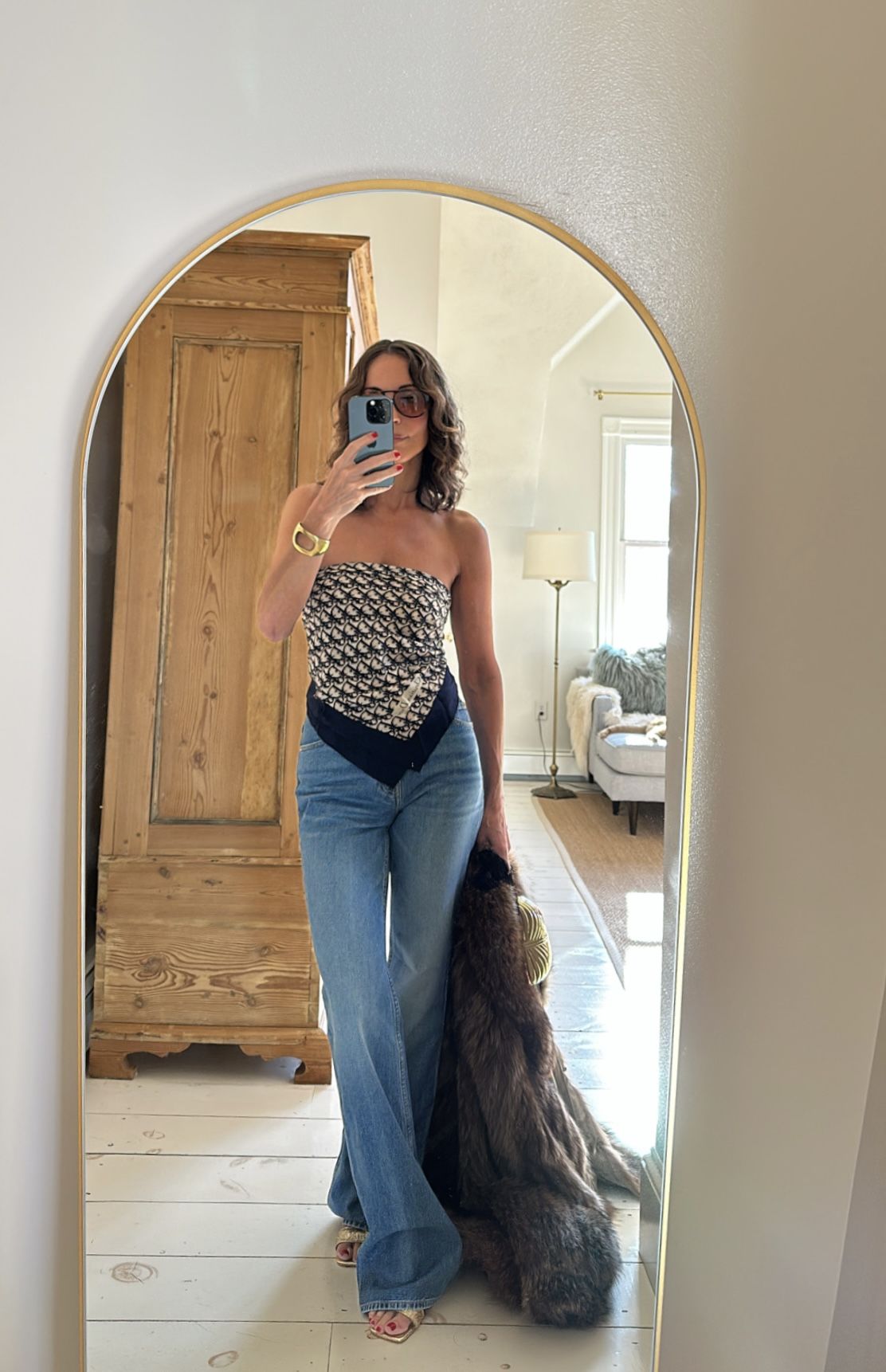 Larissa Mills wearing blue jeans and a scarf top