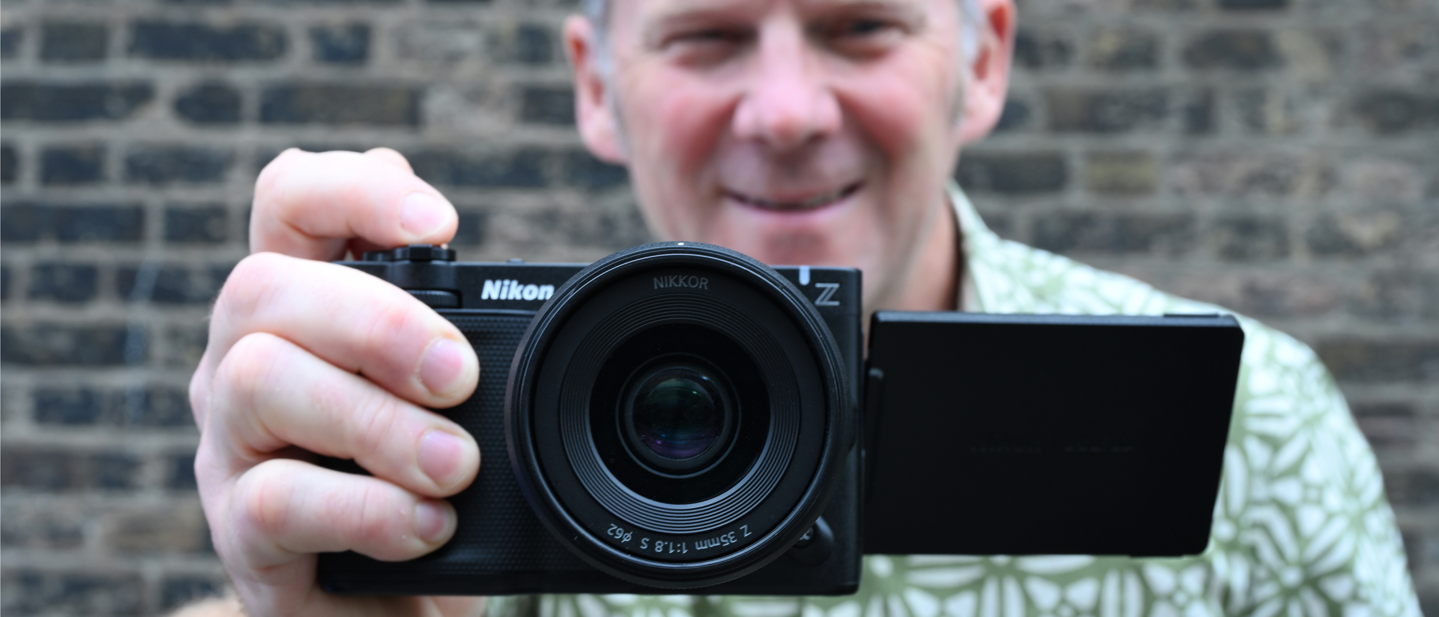 Man holding Nikon ZR video camera