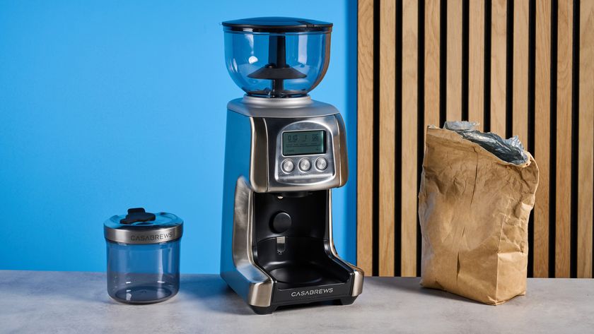 the casabrews tornado coffee grinder in silver showing the LED screen, grind adjustment dial, and photographed against a blue background 