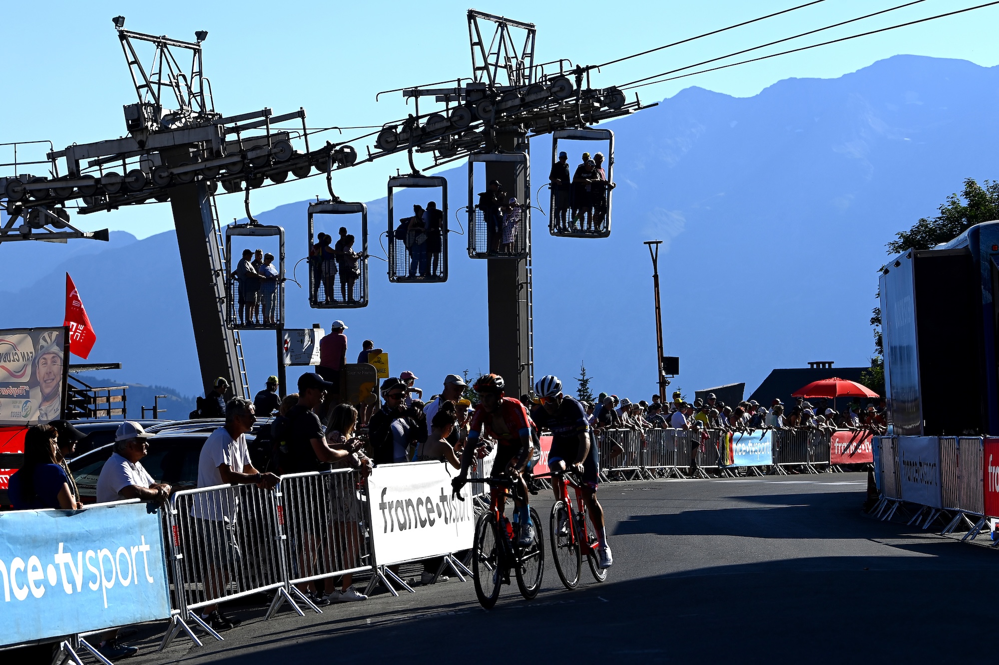ALPE D'HUEZ, FRANCE - JULY 14: (L-R) Dylan Teuns of Belgium and Team Bahrain Victorious and Tony Gallopin of France and Team Trek - Segafredo cross the finish line during the 109th Tour de France 2022, Stage 12 a 165,1km stage from Brian&amp;ccedil;on to L'Alpe d'Huez 1471m / #TDF2022 / #WorldTour / on July 14, 2022 in Alpe d'Huez, France. (Photo by Tim de Waele/Getty Images)