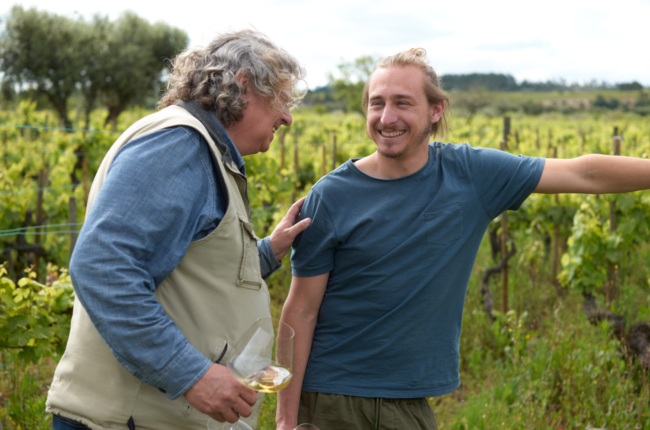 Two men standing in a vineyard