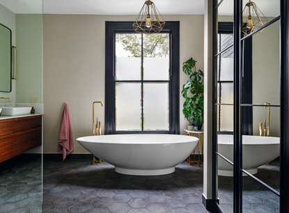 A bathroom with a sculptural tub and large windows