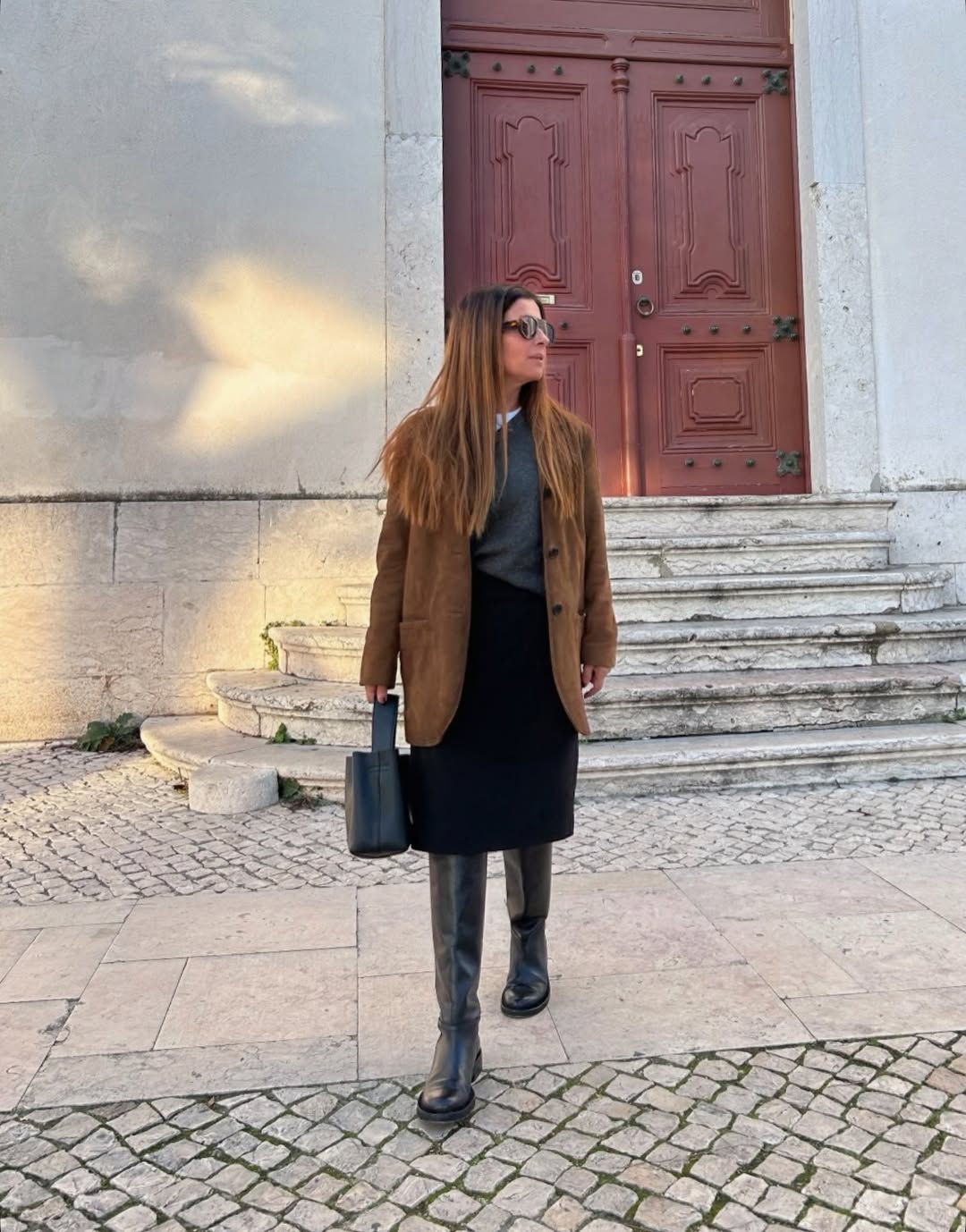 Woman wearing layering outfit idea 2026.