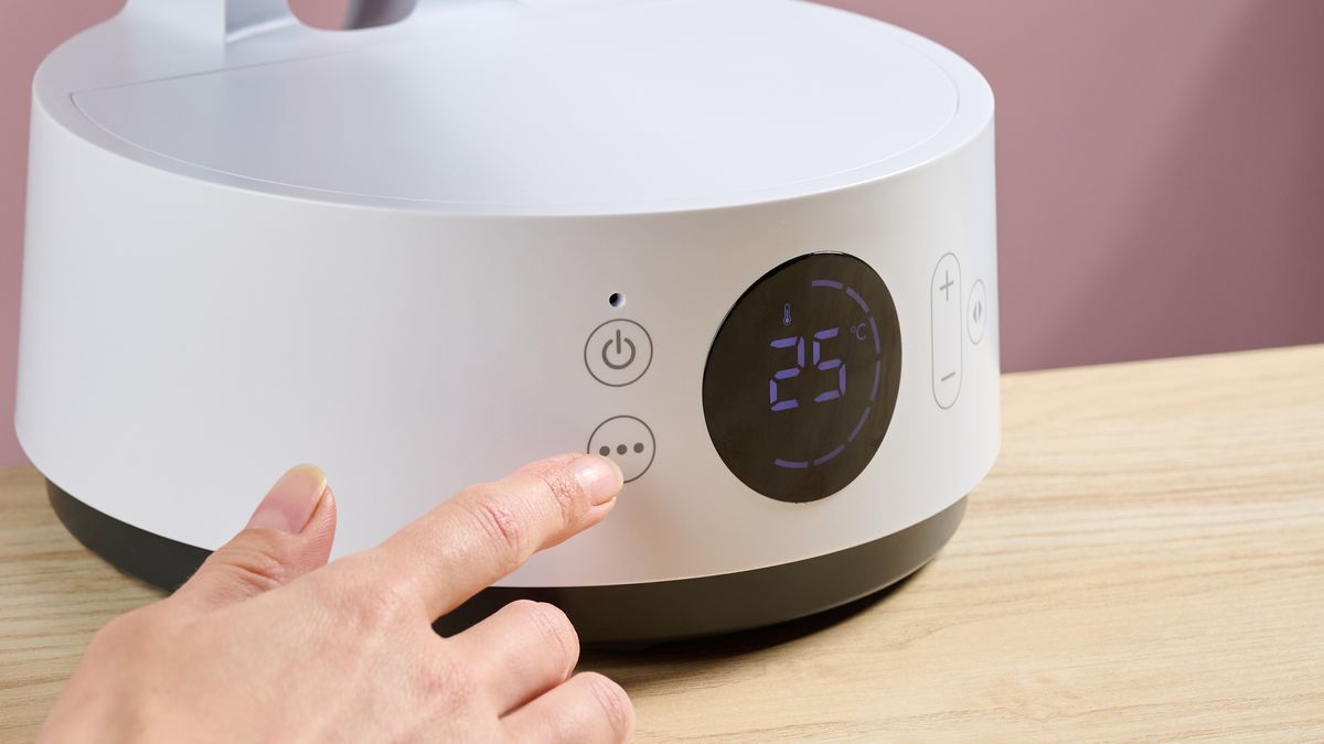A woman is touching the mode cycle button.