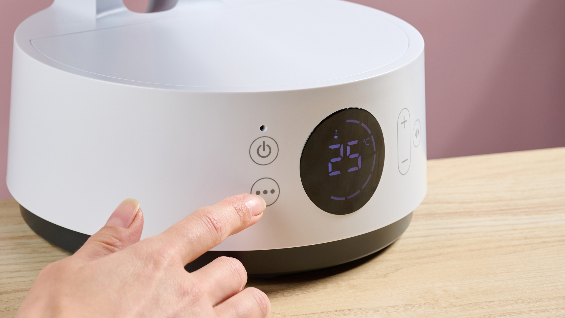 A woman is touching the mode cycle button.