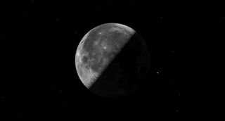 a half illuminated moon against a black background.