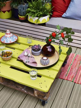 pallet table painted with bright yellow paint