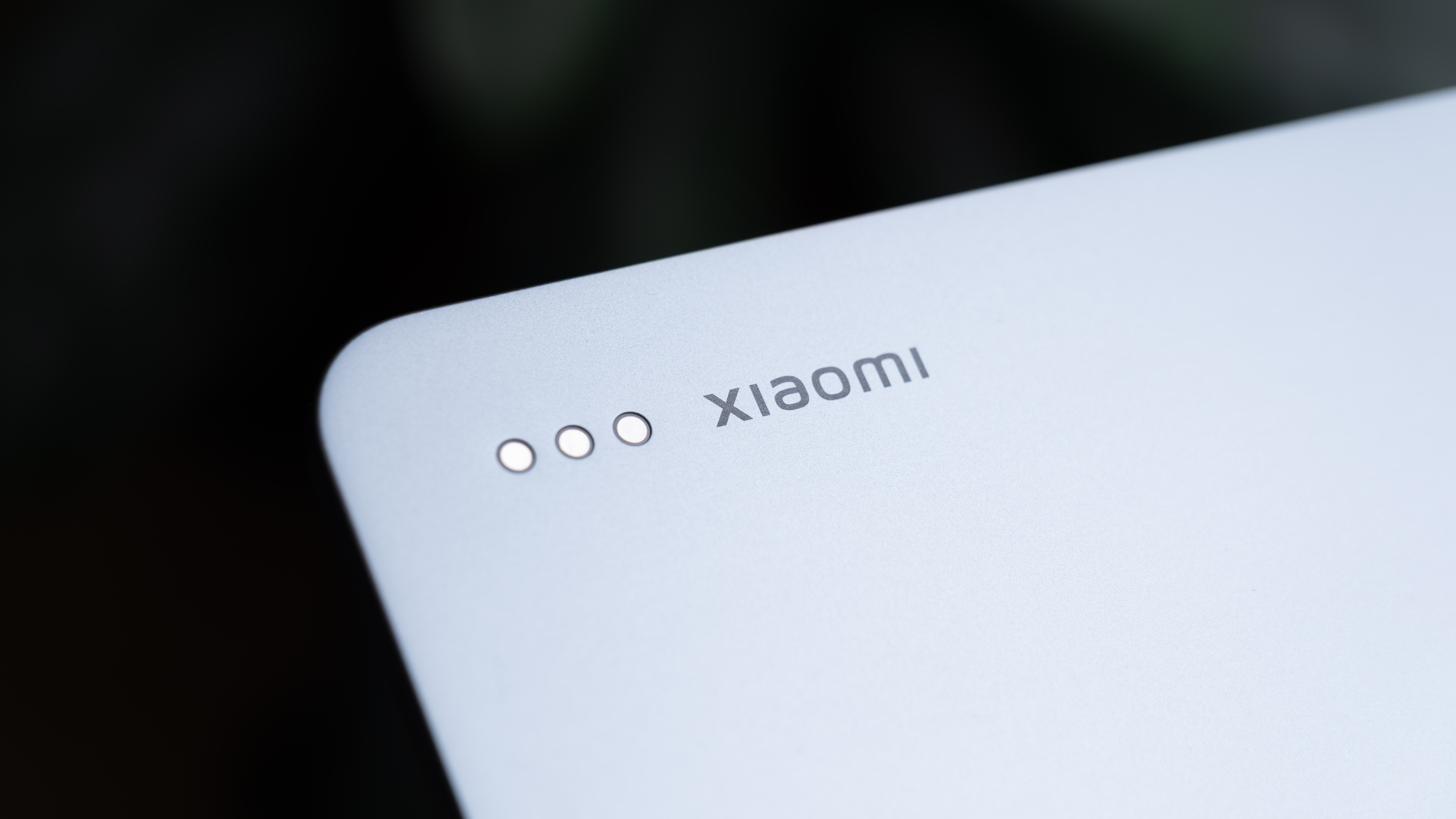 Close-up of the Xiaomi logo and rear contact pins on the back of the Xiaomi Pad 8 Pro.