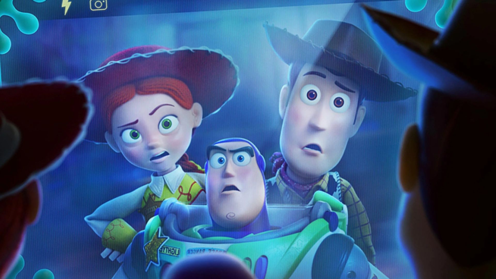 Jessie, Woody and Buzz look at Lilypad's screen in shock