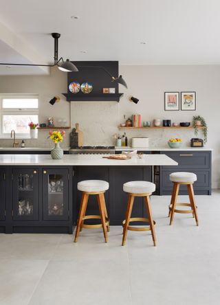 Dani Ellis home: blue Shaker-style kitchen with island and bar stools