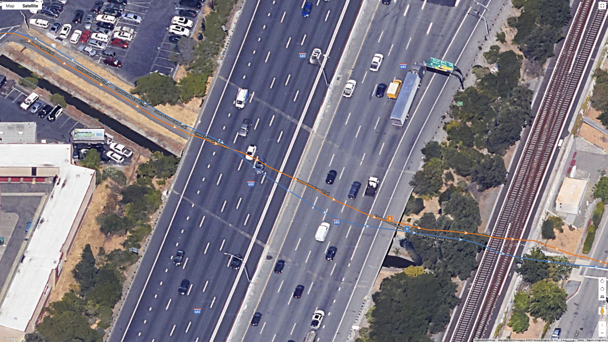 A Google Maps satellite image showing how the COROS PACE 4 (blue line) compares to the Garmin Forerunner 970 (orange line) for dual-frequency GPS accuracy for a suburban route.