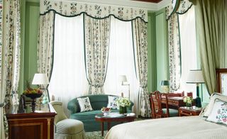 Classical interior of hotel suite with flowery curtains