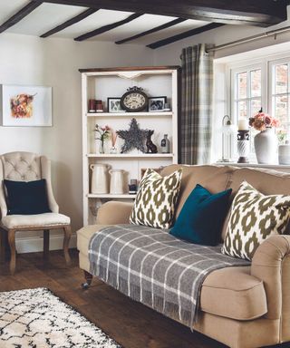 Brown sofa, grey rug, white armchair, white rug, shelves