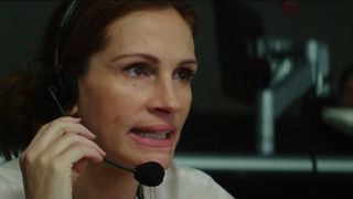 Julia Roberts talks into a headset at a TV news station in Money Monster