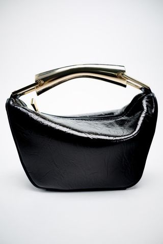 black leather bag with gold handle