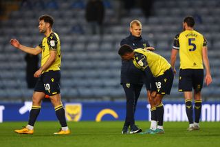 Oxford United season preview 2023/24 Marcus McGuane of Oxford United looks dejected as they are consoled by Liam Manning, Manager of Oxford United, after the Sky Bet League One match between Oxford United and Portsmouth at Kassam Stadium on April 18, 2023 in Oxford, England. (Photo by Catherine Ivill/Getty Images)