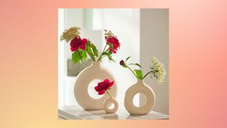 Two circular vases with flowers in them