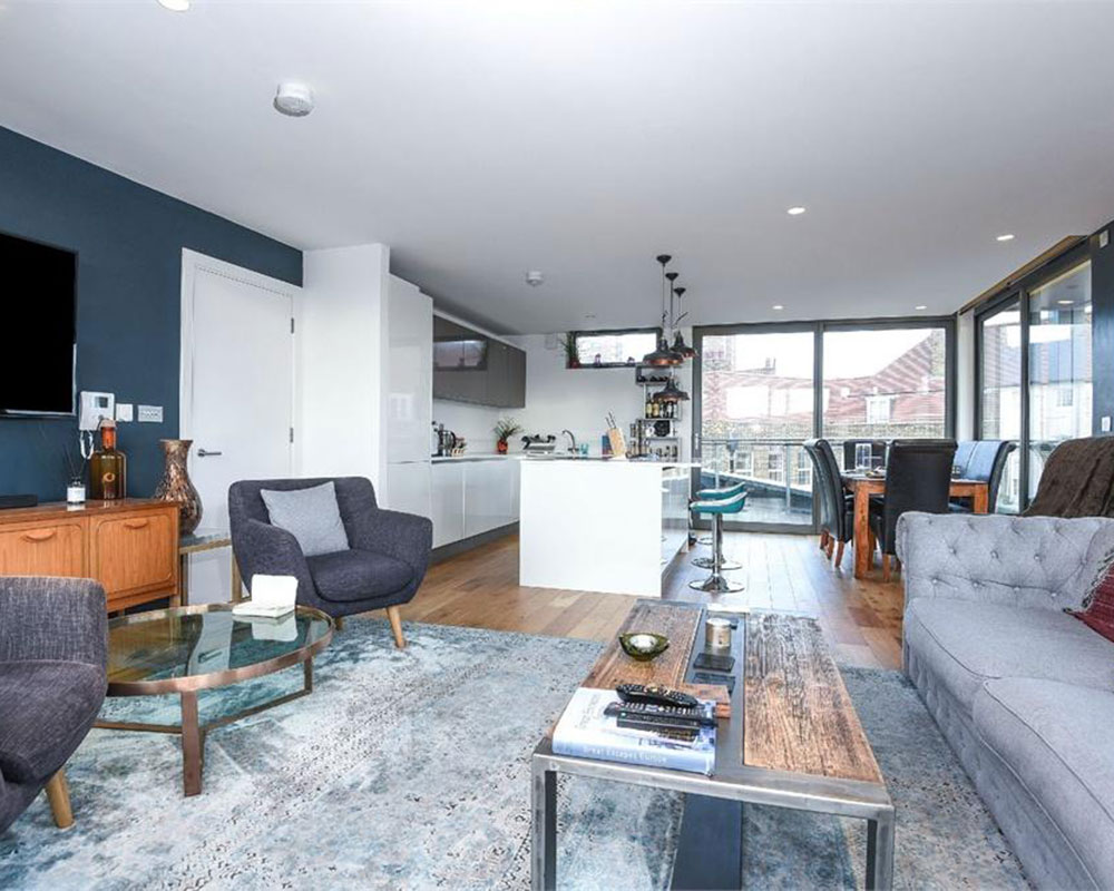 living room with wooden flooring and sofa set with cushions