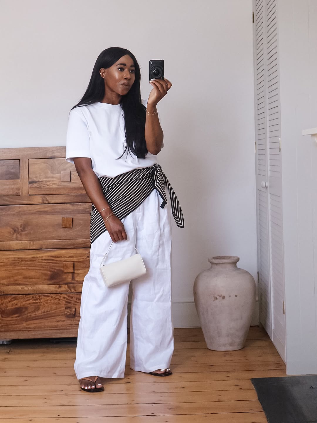 Lois wearing white Arket t-shirt