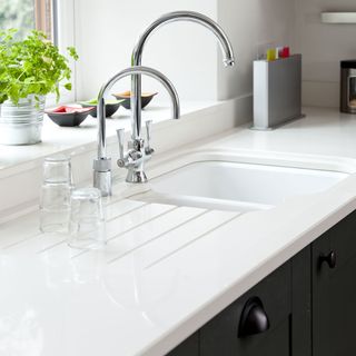 kitchen with white worktop and butler sink