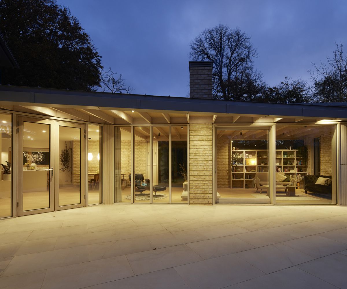 A contemporary glazed extension with an extended roof creating a covered terrace