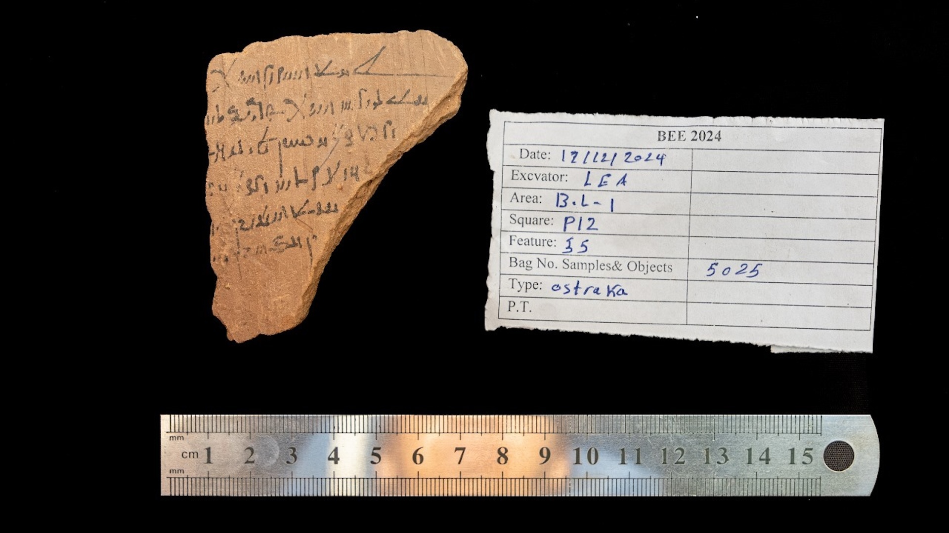 a fragment of pottery with writing on it