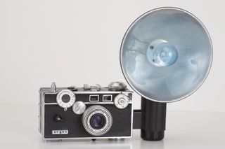Argus C3 35mm film rangefinder camera (circa 1940) with a Cintar 50mm f3.5 lens and flash attachment