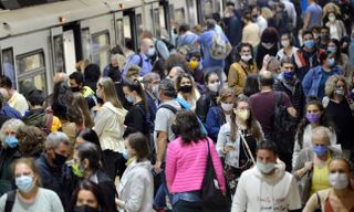 A crowd of people wearing masks at a subway station in Bulgaria.