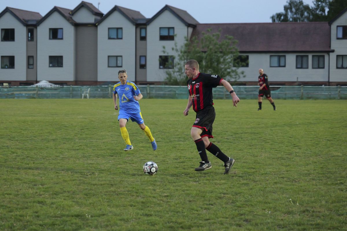 Panasonic Lumix S1 II sample gallery: footballers in action during game at last light