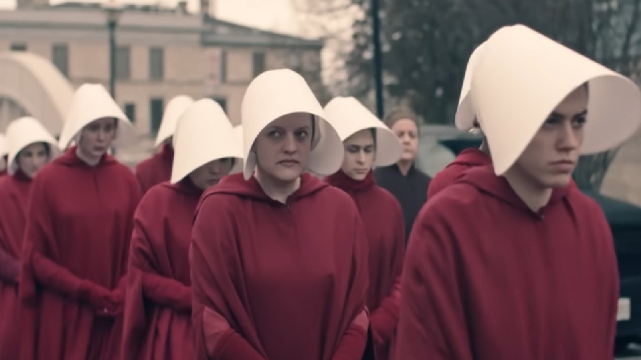 Elisabeth Moss as June walking in a line with other handmaids in a Handmaid's Tale.