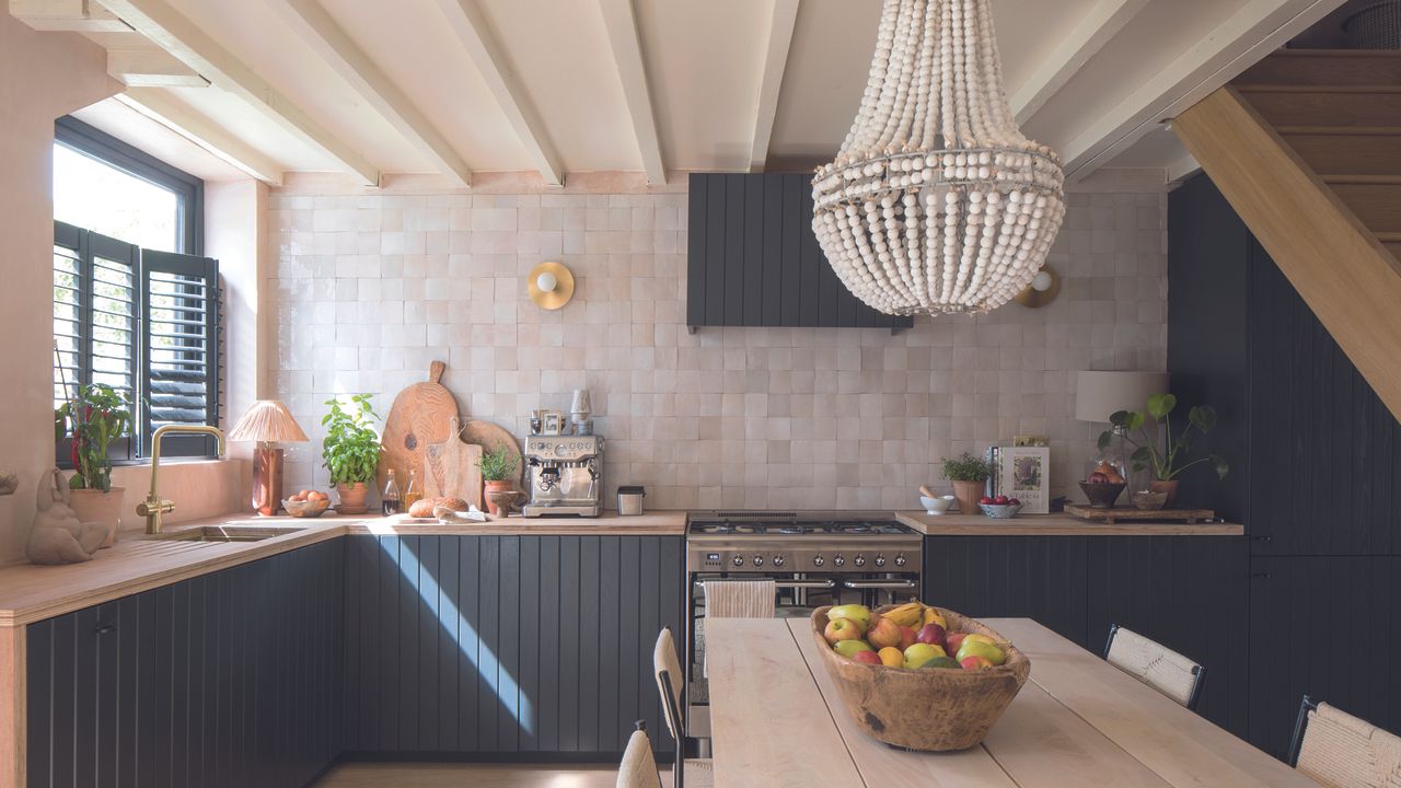 Kitchen with navy shiplap cabinets and wooden table