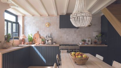 Kitchen with navy shiplap cabinets and wooden table