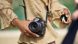 Promotional shot of a woman with Nikon DSLR camera