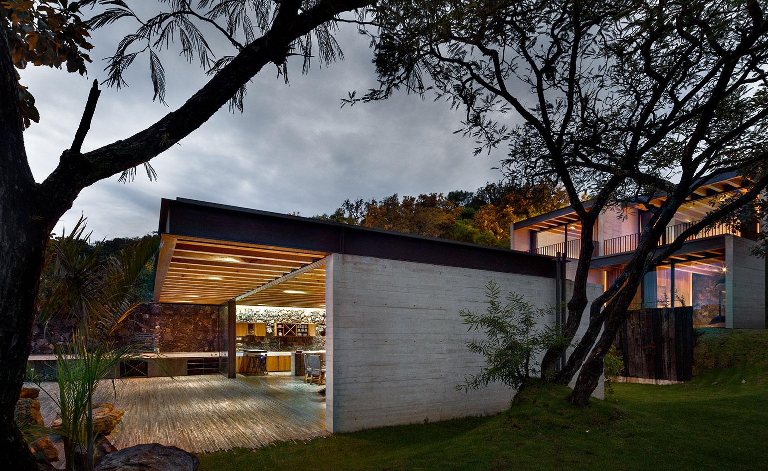 The house's simple palette of honest materials includes a cantilevering steel roof structure
