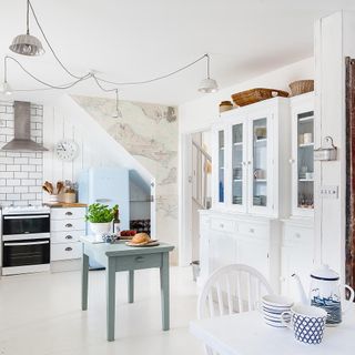 white kitchen with cabinets and table