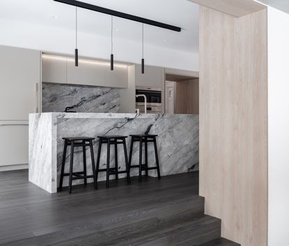 A white kitchen with dark grey floor