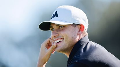A close-up shot of Swedish golfer Ludvig Aberg smiling