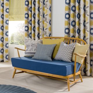 room with mustard curtain and bench