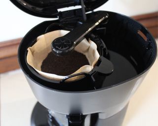 Close-up of ground coffee inside Mr. Coffee 5-cup drip filter coffee maker